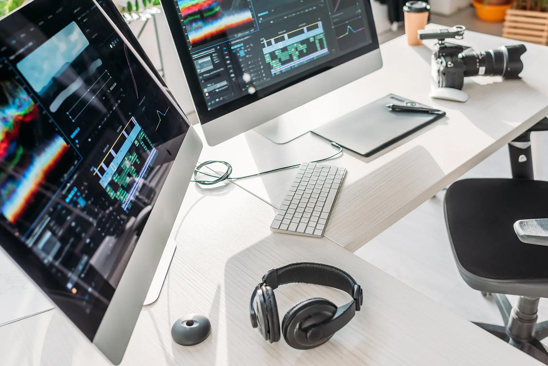 Video editing workstation with dual monitors showing an edit timeline and color scopes