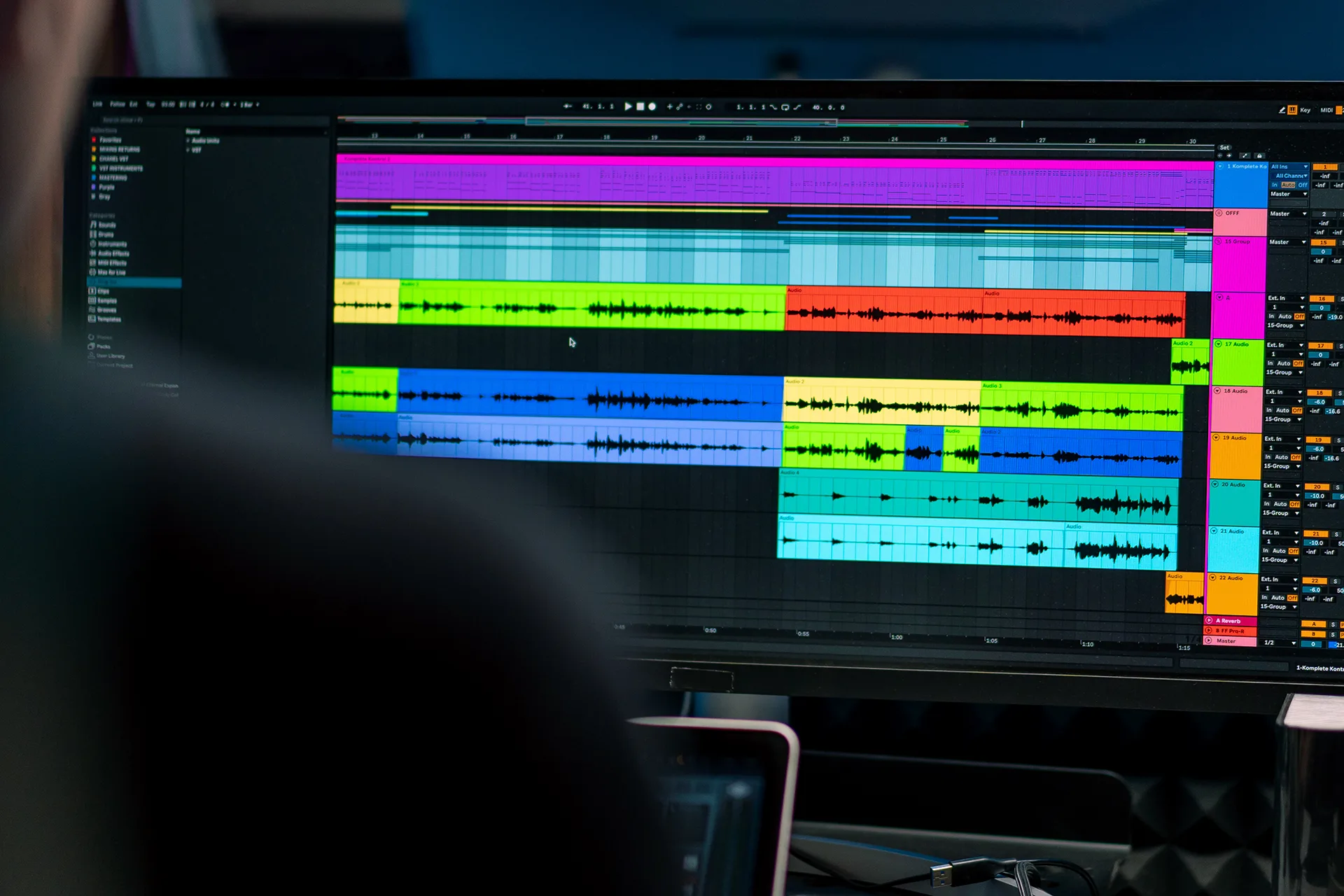 Digital audio workstation timeline with layered color-coded waveforms